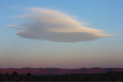 Francisco Kjolseth  |  The Salt Lake Tribune
A lenticular cloud formation appears at sunrise from Murphy's Campground on the White Rim Trail in Canyonlands National Park in May, 2013.