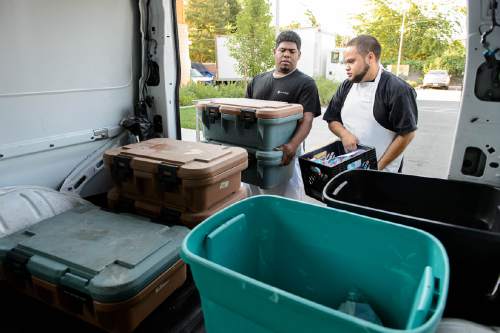 Trent Nelson  |  The Salt Lake Tribune
Alex Cruz and Martin Solis load food for the Utah Community Action Program's hot school meal program in Salt Lake City on Tuesday, Aug. 16, 2016. The CAP Central Kitchen makes and delivers more than 4,500 hot meals a day to Head Start programs, child care centers, Utah charter schools and more. After delivered to the classrooms, the meals are served family style on plates (no disposable paper products).
