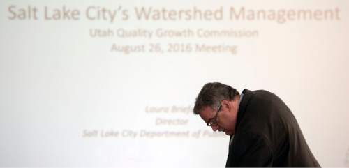 Steve Griffin / The Salt Lake Tribune

John Bennett, of the Quality Growth Commission, prepares a slide projector as the commission holds a meeting to discuss  a contentious issue involving Salt Lake City's authority to regulate land use in the Wasatch Front canyons. The meeting was held at the State Capitol, Senate Building in Salt Lake City Friday August 26, 2016.