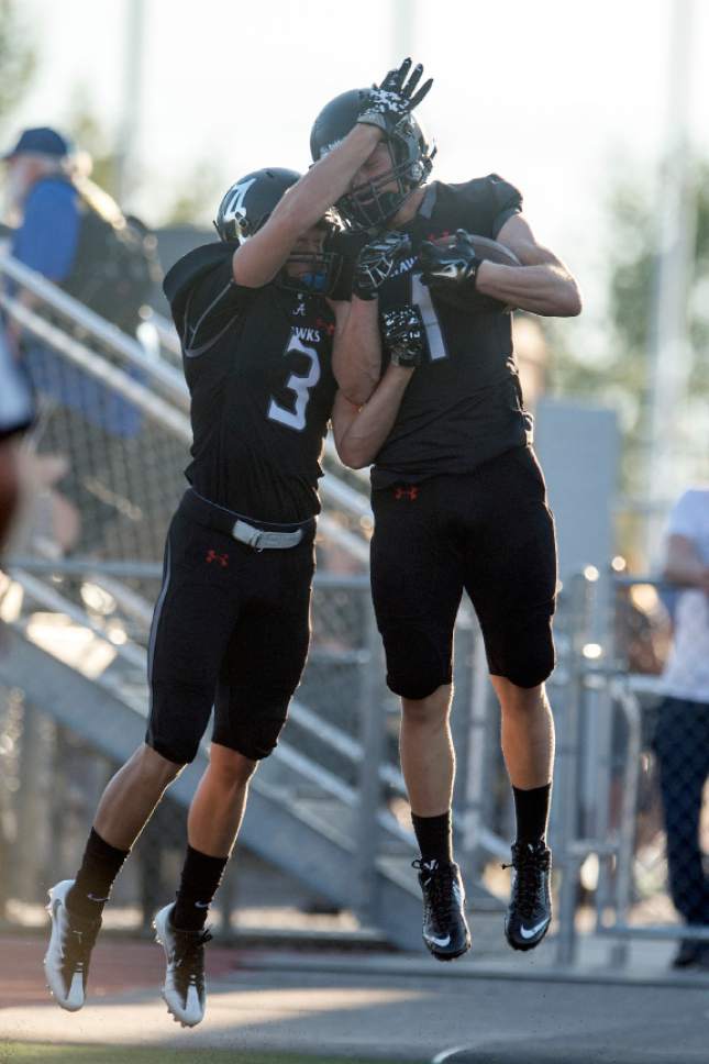 Chris Detrick  |  The Salt Lake Tribune
Alta's Zach Engstrom (1) and Alta's Landon Maxfield (3) celebrate after Engstrom scored a touchdown during the game at Alta High School Friday August 19, 2016.