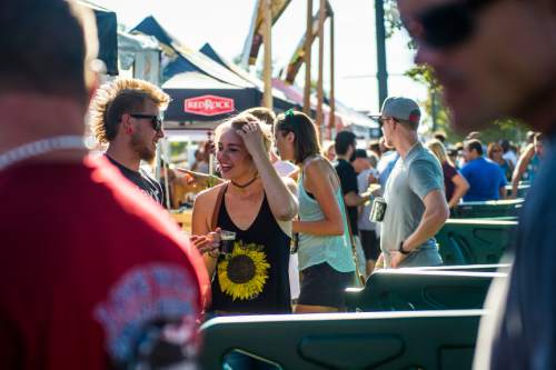 Chris Detrick  |  The Salt Lake Tribune
Patrons enjoy their beer samples during the 7th annual Utah Beer Festival at the Utah State Fair Park Saturday August 27, 2016. The festival featured over 150 different beers and ciders.