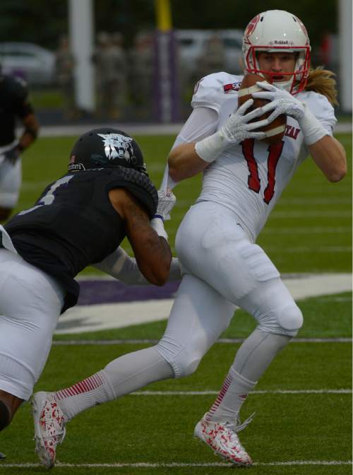 Leah Hogsten  |  The Salt Lake Tribune
Southern Utah Thunderbirds Mike Sharp (11) is pulled down by Weber State Wildcats cornerback Devonte Johnson (5). Southern Utah University leads Weber State University 17-0, October 2, 2015 at Stewart Stadium in Ogden.