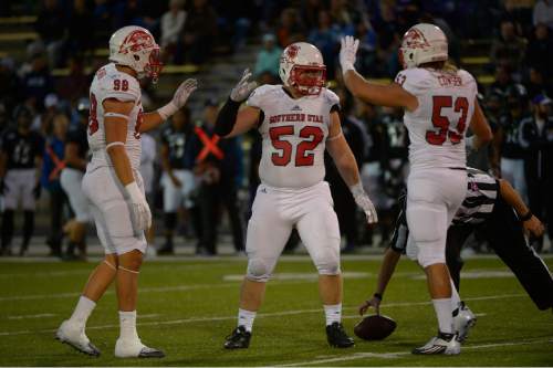 Leah Hogsten  |  The Salt Lake Tribune
Southern Utah Thunderbirds defensive tackle Shadrach Ennis (52) celebrates his quarterback sack with teammates Southern Utah Thunderbirds defensive lineman Chance Bearnson (98) and Southern Utah Thunderbirds defensive end James Cowser (53). Southern Utah University leads Weber State University 17-0, October 2, 2015 at Stewart Stadium in Ogden.