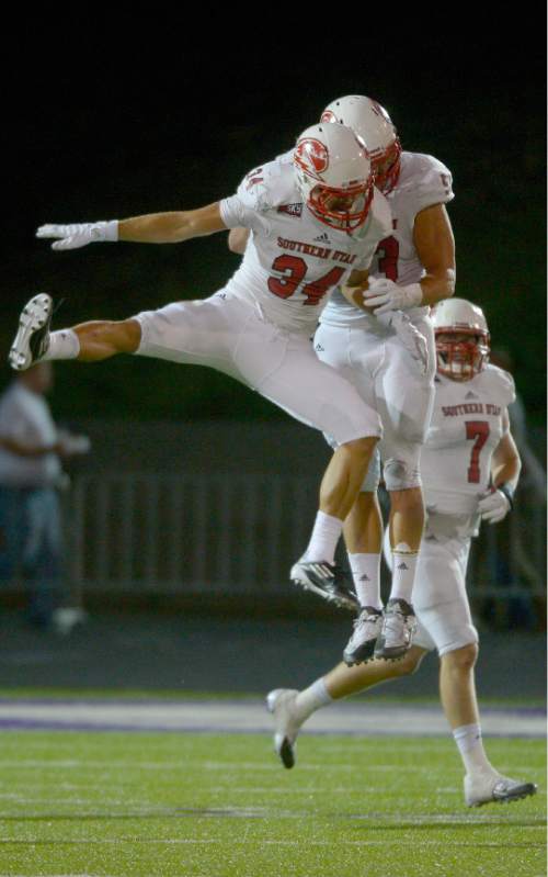 Leah Hogsten  |  The Salt Lake Tribune
Southern Utah Thunderbirds linebacker Mike Needham (34) celebrates with Southern Utah Thunderbirds defensive end James Cowser (53) after Needham intercepted a pass intended for Weber State Wildcats wide receiver Darryl Denby (3). Southern Utah University defeated Weber State University 44-0, October 2, 2015 at Stewart Stadium in Ogden.