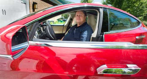 Steve Griffin  |  The Salt Lake Tribune

Rick Votaw sits in the driver's seat of his new $140,000 all-electric Tesla car in his Sandy home June 20, 2014.