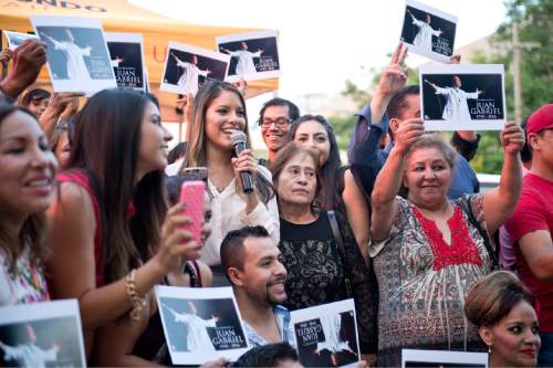 Lennie Mahler  |  The Salt Lake Tribune

Silvana Effio of Telemundo 10 Utah gathers people for a photo during a celebration of Mexican singer-songwriter Juan Gabriel, who died of a heart attack Aug. 28. Telemundo 10 Utah hosted the vigil Monday, Aug. 29, 2016, in front of Vivint Smart Home Arena, where Gabriel was scheduled to perform Oct. 7.