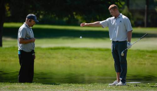 Francisco Kjolseth | The Salt Lake Tribune
Patrick Fishburn of Ogden, Utah, is unable to avoid a penalty stroke after removing his shoe to take a shot on the edge of a pond at Riverside Country Club in Provo during the final round of the Utah Open golf tournament on Sunday, Aug. 28, 2016.