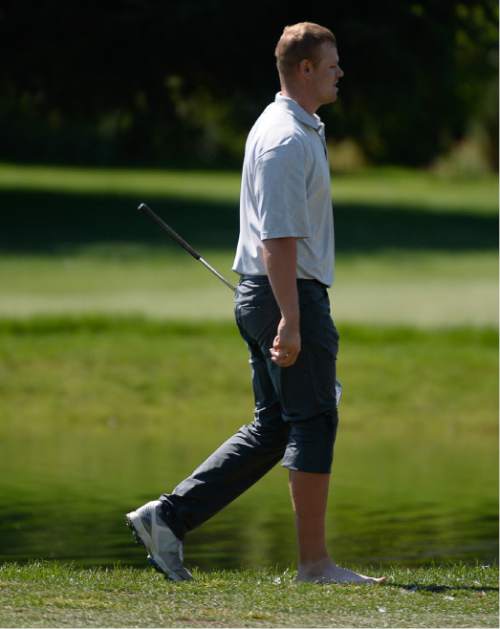 Francisco Kjolseth | The Salt Lake Tribune
Patrick Fishburn of Ogden, Utah, is unable to avoid a penalty stroke after removing his shoe to take a shot on the edge of a pond at Riverside Country Club in Provo during the final round of the Utah Open golf tournament on Sunday, Aug. 28, 2016.