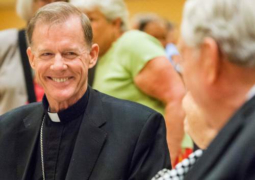 Rick Egan  |  The Salt Lake Tribune

Departing Archbishop John C. Wester smiles as he visits with Barbara and LDS apostle M Russell Ballard  at a reception at the Little America on Sunday, May 31, 2015.