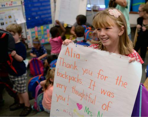 Al Hartmann  |  The Salt Lake Tribune
Alia Leonard holds a thank you note from a kindergarten class at Bennion Elementary School on Wednesday, Aug. 31.  She raised enough money for more than 300backpacks with school supplies for every student in the school.