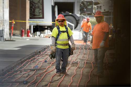 Scott Sommerdorf   |  The Salt Lake Tribune  
Workers busy with the "mid block walkway" to the new Eccles Theater next door to the 111 high-rise on Main Street, Wednesday, August 31, 2016.