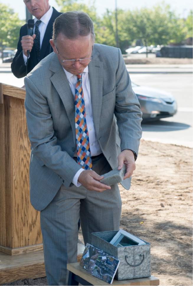 Rick Egan  |  The Salt Lake Tribune

Sen. Stuart Adams places items in a time capsule, symbolizing partnerships behind the Hill Field road project. Wednesday, August 31, 2016.