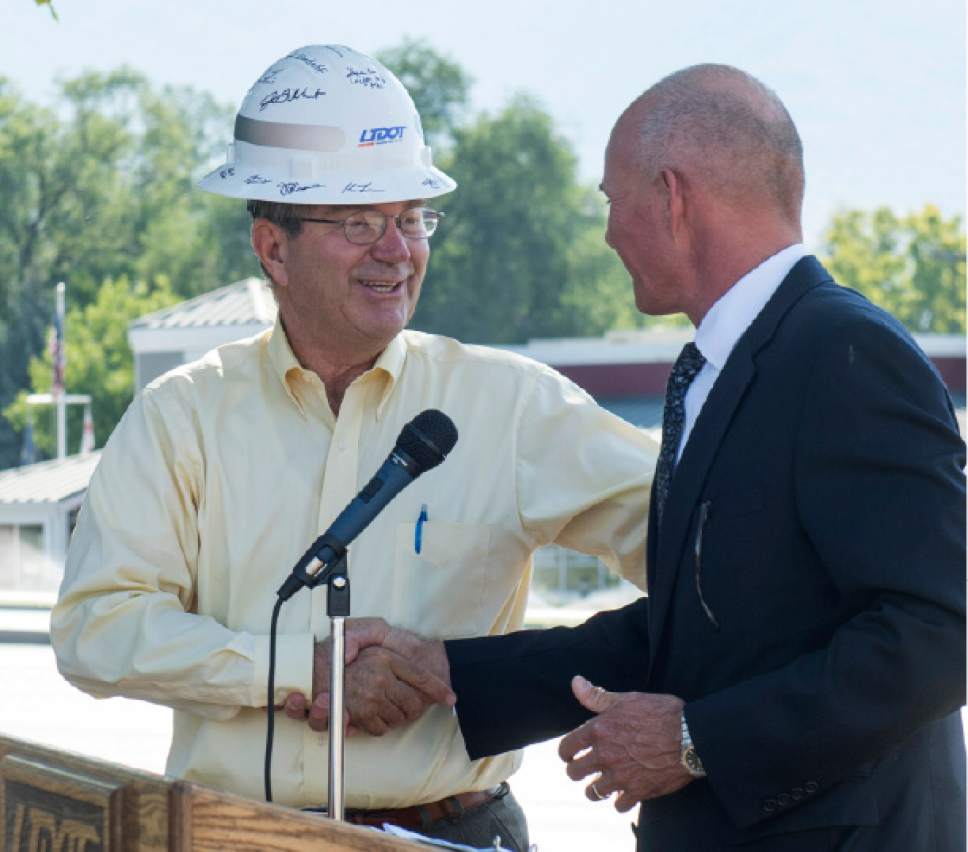 Rick Egan  |  The Salt Lake Tribune

Layton City Mayor Bob Stevenson is presented a hard hat by Utah Department of Transportation Executive Director Carlos Braceras, during a ceremony to complete improvements in Layton including a ThrU Turn, a single-point urban interchange and additional lanes at Hill Field Road and I-15, Wednesday, August 31, 2016.