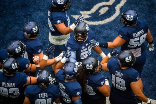 Chris Detrick  |  The Salt Lake Tribune
Utah State Aggies defensive end Ricky Ali'ifua (95) and his teammates before the game at Maverik Stadium Thursday September 1, 2016.