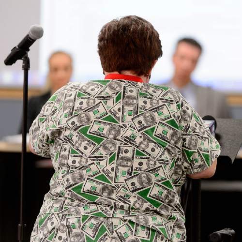 Trent Nelson  |  The Salt Lake Tribune
Tammi Diaz, dressed in an outfit printed with currency, speaks in opposition to the hiring of Jerry Benson as the new president/CEO of the Utah Transit Authority (UTA), Wednesday August 31, 2016.