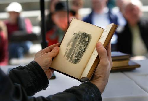 Scott Sommerdorf   |  The Salt Lake Tribune
Rare book dealer Tony Weller helps collector Kellie Wood with an assessment of her rare book during a rare book appraisal session at the 16th annual Book Festival, sponsored by the Utah Humanities Council. The event is a two-day outdoor festival taking place on Library Square Saturday and Sunday that includes authors, music, book arts, a poetry slam, writing activities and more, Saturday, September 28, 2013.