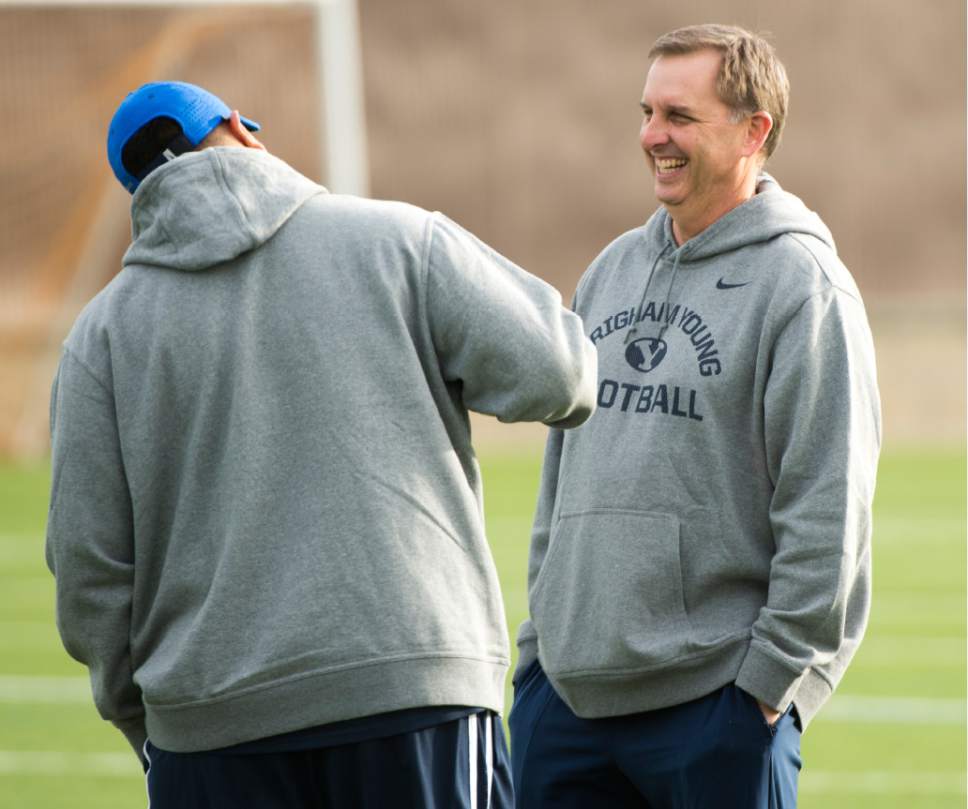 Rick Egan  |  The Salt Lake Tribune

BYU head coach Kalani Sitake  shares a laugh with quarterback coach Ty Detmer on the second day of spring practice, in Provo, Thursday, March 3, 2016.