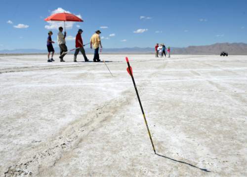 Al Hartmann  |  The Salt Lake Tribune
Archers at the U.S. Flight Archery Association's annual meet walk several hundred meters from the shooting line to find their arrows on the Salt Flats on Friday. This is a big event with international competitors where archers shoot for distance with different kinds of bows, from high tech crossbows to traditional primative wooden bows.  Most are handmade with different pull weights .