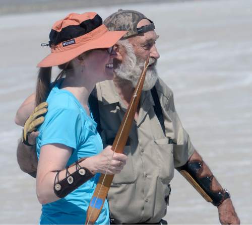 Al Hartmann  |  The Salt Lake Tribune
Candace Sall, an archeology museum currator from the University of Missouri gets a congratulations hug from meet "captain" David Hayes after shooting her first round of arrows at the U.S. Flight Archery Association's  annual meet on the Salt Flats Friday.  It runs through Sunday. She entered last year for the first time and earned a world record in the primative bow category. This is a big event with international competitors where  archers shoot for distance with different kinds of bows, from high tech crossbows to traditional primative wooden bows.  Most are handmade with different pull weights .