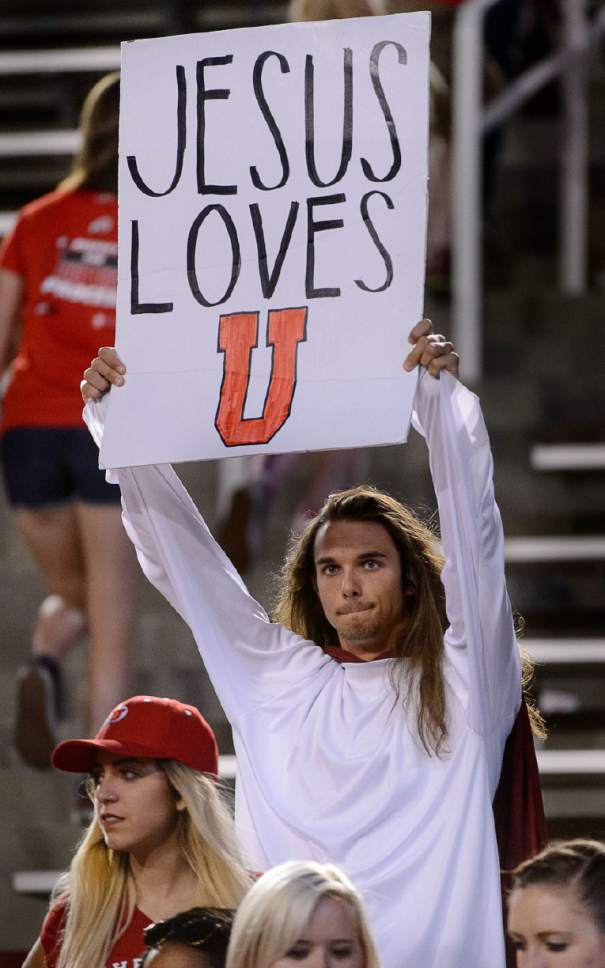 Trent Nelson  |  The Salt Lake Tribune
A Utah fan holds a sign reading, "Jesus loves U" as the University of Utah Utes host the Southern Utah University Thunderbirds, NCAA football at Rice-Eccles Stadium in Salt Lake City, Thursday September 1, 2016.