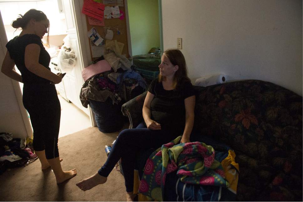 Leah Hogsten  |  The Salt Lake Tribune
Petrina Westman, 14, tells her mother Kimberly Gross about her first day of school. Kimberly Gross and her two daughters live in a two-bedroom basement apartment in Taylorsville, through The Road Home's rapid rehousing program. Gross received assistance for rent for three months, but now complications with her health and lack of ability to hold a job due to poor health has her fearing that she might be evicted and heading back to live at a shelter.