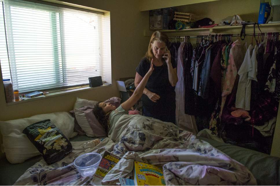Leah Hogsten  |  The Salt Lake Tribune
Destiny Westman pleads with her mother for her cell phone to watch cartoons while her mother Kimberly Gross is on a call. Kimberly Gross and her two daughters live in a two-bedroom basement apartment in Taylorsville, through The Road Home's rapid rehousing program. Gross received assistance for rent for three months, but now complications with her health and lack of ability to hold a job due to poor health has her fearing that she might be evicted and heading back to live at a shelter.