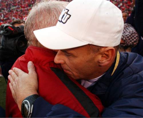Danny La | The Salt Lake Tribune

Utah coach Ron McBride (left) and BYU coach Gary Crowton exchange a hug at the end of the game in 2002. Utah beat BYU 13-6.