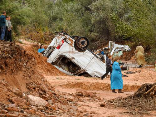 Trent Nelson  |  The Salt Lake Tribune
People take in the scene in a Hildale wash where a flash flood killed nine people (with four still missing) Tuesday September 15, 2015., the day after an SUV and a van were washed off a road during a flash flood in this polygamous Utah-Arizona border community.