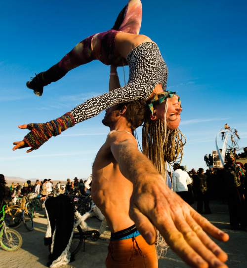 Rick Egan  |  The Salt Lake Tribune

Adam Heiner, and Sae Bluff, San Diego, CA,  do some acrobatics, at the Burning Man Festival, in the Black Rock Desert, 100 miles north of Reno, NV, Saturday, September 3, 2016.
