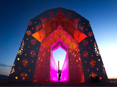 Rick Egan  |  The Salt Lake Tribune

The colors change, and drums sound as you walk though "Roshanai"  (Illuminate) by Charles Gadeken, San Francisco.  The 108-ft long tunnel of light and sound, the entrance inspired by the Great Mosque of Isfahan in Iran, at the Burning Man Festival, in the Black Rock Desert, Saturday,September 3, 2016.