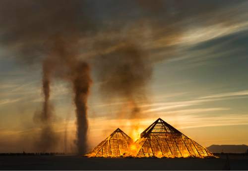 Rick Egan  |  The Salt Lake Tribune

The "Catacomb of Veils" by Dan Sullivan and the Catacomb Crew, San Francisco, CA, goes up in flames at sunrise, at the Burning Man Festival, in the Black Rock Desert, 100 miles north of Reno, NV, Friday, September 2, 2016.