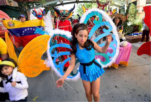 Scott Sommerdorf   |  The Salt Lake Tribune  
Girls in the Venezuelan contingent, dressed as butterflies dance down Rio Grande St. during the first Annual Hispanic Heritage Parade & Street Festival at The Gateway on Saturday.