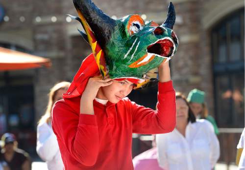 Scott Sommerdorf   |  The Salt Lake Tribune  
Daniel Reams, part of the Venezuelan contingent, puts on the head of "Diablos" prior to the first Annual Hispanic Heritage Parade & Street Festival at The Gateway, Saturday, September 3, 2016.