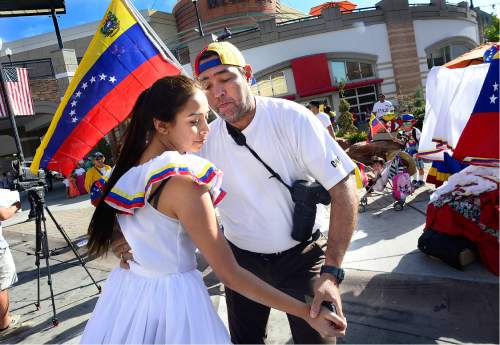 Scott Sommerdorf   |  The Salt Lake Tribune  
Venezuelans Oracio Perez and his daughter Isabelle dance prior to the first Annual Hispanic Heritage Parade & Street Festival at The Gateway, Saturday, September 3, 2016.