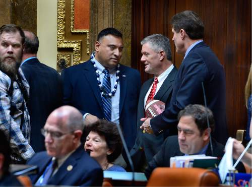 Scott Sommerdorf   |  The Salt Lake Tribune  
BYU head football coach Kalani Sitake, left, leans in to speak to Utah head coach Kyle Whittingham as they both visited the Utah House of Representatives, Thursday, March 3, 2016. They were later both honored for their football accomplishments by an introduction on the floor.