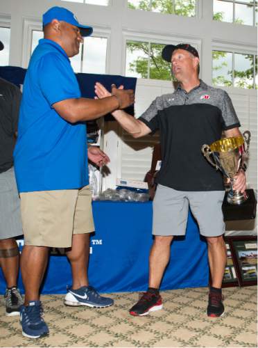 Steve Griffin / The Salt Lake Tribune

BYU head coach Kalani Sitake congratulates University of Utah head coach Kyle Whittingham as they announce the results of the rivalry for charity (National Kidney Foundation) golf tournament at Hidden Valley Country Club in Sandy, Utah Monday June 13, 2016. The tournament pitted the Utah football team coaches against the BYU football coaches with the losing team singing the others fight song. Sitake and his team held up their end of the bargain and sang the University of Utah fight song after falling to the Utah coaches in the tournament.