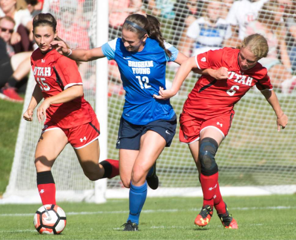 Rick Egan  |  The Salt Lake Tribune

Avery Calton Walker, (12) heads down the field with the ball, as Natalie Vukic (15), and Paola van der Veen (6)Utah, defend, in soccer action, BYU vs. Utah, at the Ute soccer field, Monday, September 5, 2016.