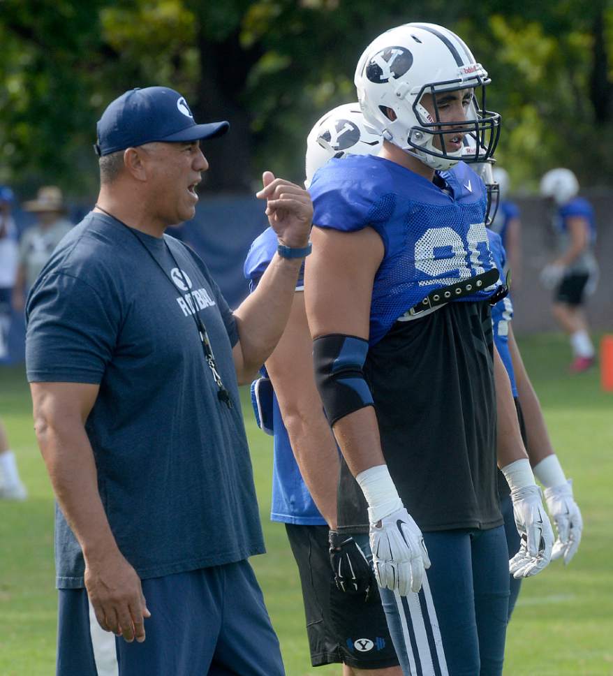 Al Hartmann  |  The Salt Lake Tribune
Steve Kaufusi coaches BYU's 2016 defensive line during practice Tuesday Aug 23 including his 6 foot 9 inch son Corbin, right.