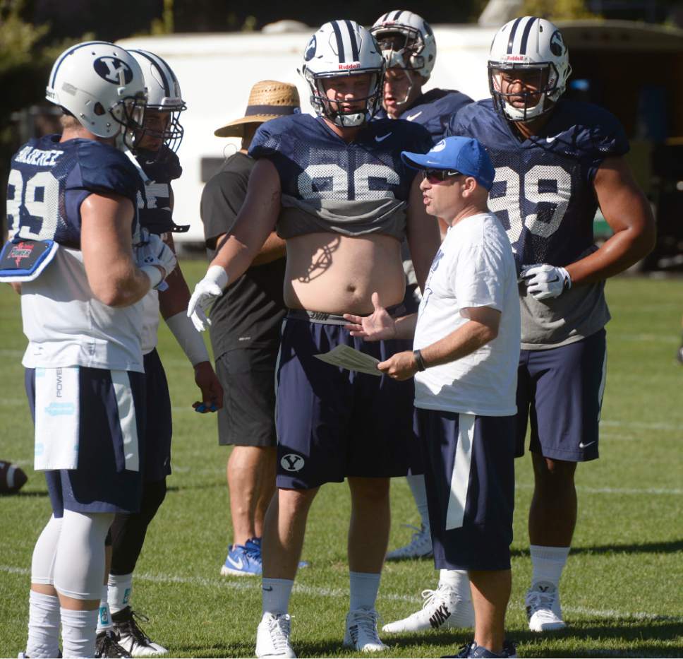Al Hartmann  |  The Salt Lake Tribune 
New BYU coach Steve Clark works with a crowded and talented field of tight end candidates during its third practice of fall camp on Monday August 8.