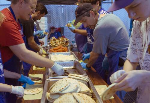 Keith Johnson | The Salt Lake Tribune
Volunteers with the Greek Orthodox Church of Greater Salt Lake City prepare Gyros during the Greek Festival in downtown Salt Lake City, September 6, 2013.