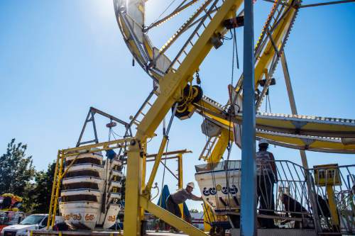 Chris Detrick  |  The Salt Lake Tribune
Evencio Gutierrez works on the Thomas Carnival Century Wheel at the Utah State Fairpark Wednesday September 7, 2016. The Utah State Fair runs September 8 – 18 at the Utah State Fairpark.