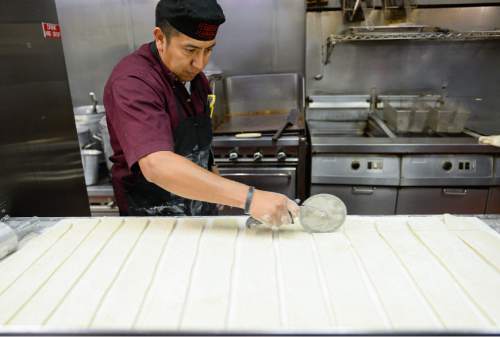 Francisco Kjolseth | The Salt Lake Tribune
Rafael Jimenez, a 15-year employee of Chuck-A-Rama, scones before baking at the original restaurant in Salt Lake.