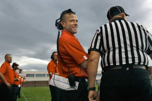 Scott Sommerdorf   |  The Salt Lake Tribune
Weber head coach Matt Hammer, smiles as he jokes with an official about a penalty call at West, Friday, August 23, 2013. Weber won 27-7 and snapped a 23-game losing streak.