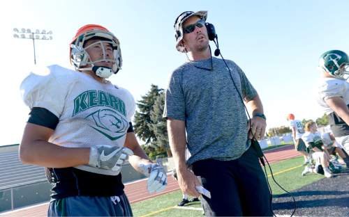 Francisco Kjolseth | The Salt Lake Tribune
Kearns football coach Matt Rickards works with wide receiver Peter Do during practice on Wednesday, Sept. 7, 2016. Coaches across the state, including Rickards, are vehemently criticizing a proposal to eliminate restrictions on prep athletes transferring between schools, saying it would create a free-for-all that encourages athletes focus on winning and entitlement, rather than than character development and overcoming adversity.