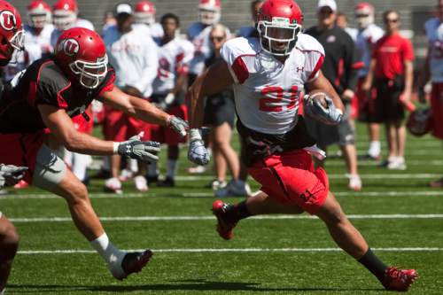 Chris Detrick  |  The Salt Lake Tribune
Harvey Langi runs past Matt Martinez during a practice at Rice-Eccles Stadium in August 2011. Langi graduated from Bingham High in December 2010 and enrolled at Utah for spring semester to be eligible for spring practices. Because he was already enrolled, he did not sign a national letter of intent on Februaryís National Signing Day, and he became a recruitable athlete one year into his LDS mission to Tampa, Fla. Langi transferred to BYU after his return.