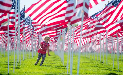 Rick Egan  |  The Salt Lake Tribune
TaylorAnn Hollingsworth, 5, Riverton, runs through flags in the Healing Field, South of Sandy City Hall at 10000 South Centennial Parkway Sandy City on Friday. The Healing Field display contains more than 3,000 American flags in remembrance of the lives lost in the Sept. 11, 2001, terrorist attacks.