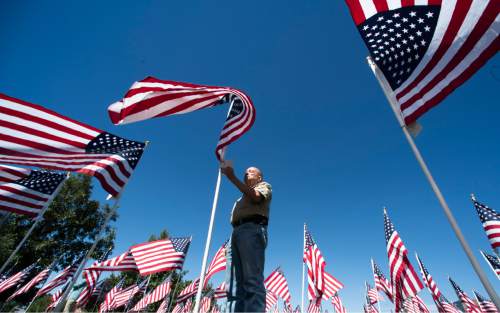 Rick Egan  |  The Salt Lake Tribune

Ron Kaiser, Pleasant Grove, reads about one of the victims of the Sept.11 terrorist attacks, on one of the flags in the Healing Field, south of Sandy City Hall at 10000 South Centennial Parkway Sandy City.  The Healing Field display contains more than 3,000 American flags in remembrance of the lives lost in the Sept. 11, 2001, terrorist attacks. Friday, September 9, 2016.