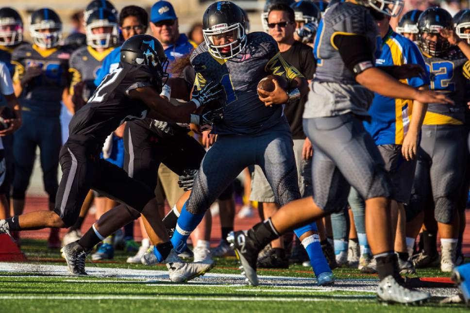 Chris Detrick  |  The Salt Lake Tribune
Alta's Drew Pan (22) pushes Taylorsville's Dane Leituala (1) out of bounds during the game at Alta High School Friday August 19, 2016.