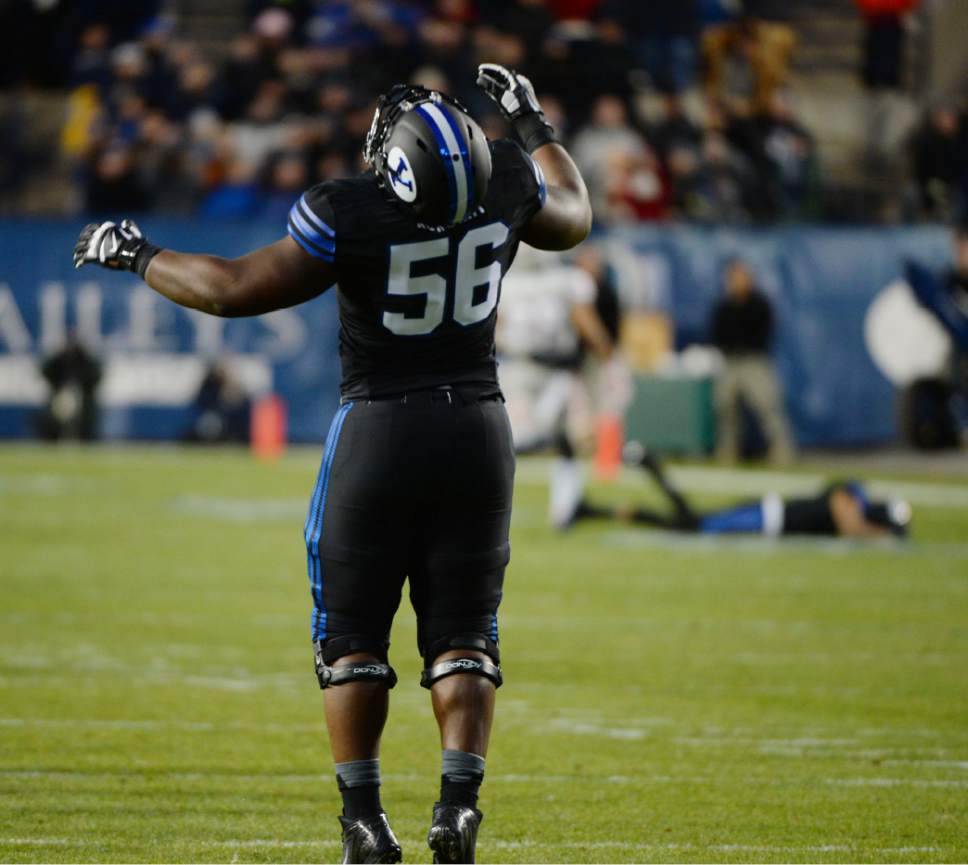 Steve Griffin  |  The Salt Lake Tribune

Brigham Young Cougars offensive lineman Tejan Koroma (56) throws his head back as he watches a long pass dropped by a teammate during first half action in the BYU versus UNLV football game at LaVell Edwards Stadium in Provo, Saturday, November 15, 2014.