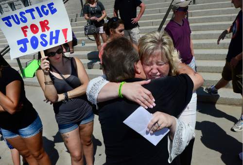 Scott Sommerdorf   |  The Salt Lake Tribune  
Josh Holt's mother Laurie Holt hugs her uncle Leonard Bell after a rally on the east steps of the Utah State Capitol that called for the release of their 24-year-old son Josh Holt, who is currently jailed in Venezuela on Saturday.